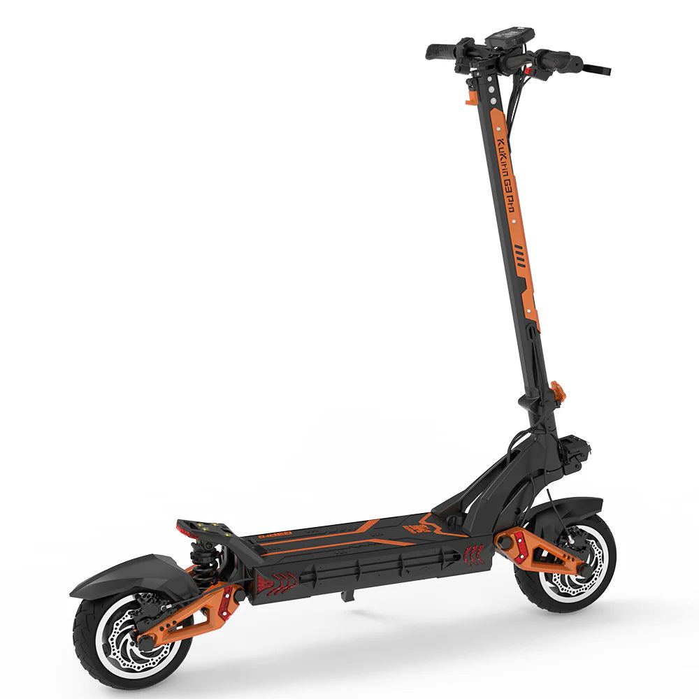 The KuKirin G3 PRO 2x 1200W električni romobil features a sleek black and orange design, reaching a maksimalna brzina of 65 km/h. It boasts a sturdy frame, large intricately-rimmed wheels, handlebars with controls, and visible suspension on both wheels. Its wide deck houses a powerful 52V 23Ah litijska baterija.
